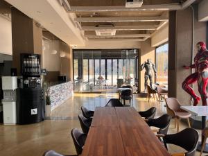 a dining room with a table and a spider man statue at Over The Mountain in Gapyeong