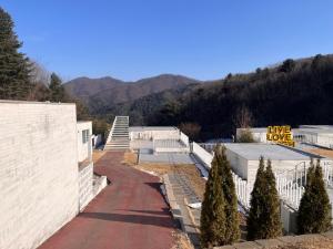 a building with stairs and trees and a sign that reads live love at Over The Mountain in Gapyeong