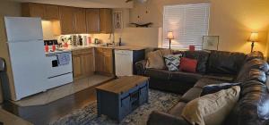 a living room with a couch and a kitchen at Lighthouse Basement Guest Suite in Provo