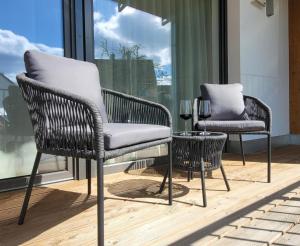 two chairs and a table on a balcony at Obermain Living in Bad Staffelstein