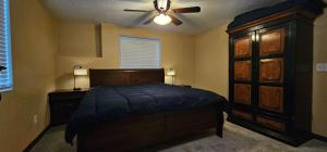 a bedroom with a bed and a ceiling fan at Lighthouse Basement Guest Suite in Provo