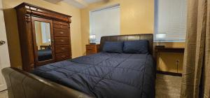 a bedroom with a bed and a dresser and a desk at Lighthouse Basement Guest Suite in Provo +7 photos
