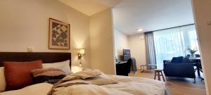 a bedroom with a bed and a living room at Obermain Living in Bad Staffelstein
