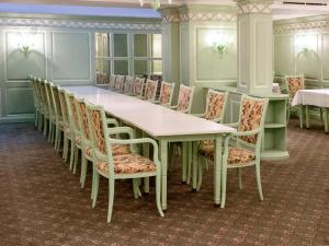 a room with a long table and chairs at DORMERO Hotel Halle in Halle an der Saale