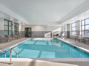 a large pool with blue water in a building at Hyatt House Schenectady / Mohawk Harbor in Schenectady