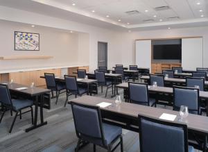 a conference room with tables and chairs and a screen at Hyatt House Schenectady / Mohawk Harbor in Schenectady +37 photos