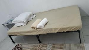 a bench with two pillows on top of it at Eastdee AIRCON ROOM - RO1 in Biqui