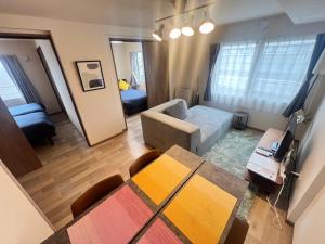a living room with a couch and a table at ホロムア澄川 in Sapporo