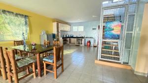 a kitchen and dining room with a table and chairs at Bantayan Beachfront Seacamp Okoy Private House Operated by In Dai Aquasports and Beach Resort in Bantayan Island