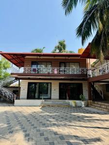 a building with a palm tree in front of it at Suites by the Glaswater in Kalyānpur