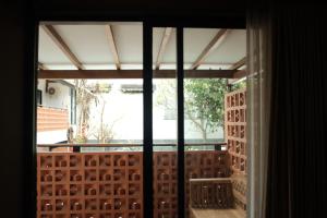 an open window with a view of a balcony at Griya Yunika in Yogyakarta