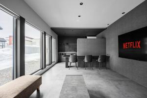 a meeting room with a table and chairs and windows at U suzukou in Asahikawa