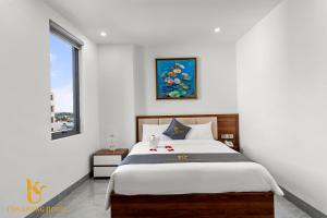 a bedroom with a large bed and a window at Tâm Khang Hotel in Móng Cái