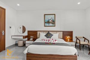 a bedroom with a large bed with red flowers on it at Tâm Khang Hotel in Móng Cái +39 photos