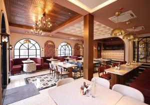 a restaurant with tables and chairs in a room at Saltstayz Autograph - Rishikesh Near Triveni Ghat in Rishīkesh