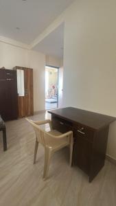 a desk and a chair in a room at Peaceful & hygienic stay , Ideal for working professionals, Great for solo female travelers in Pune