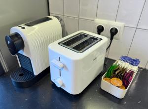 a toaster sitting on a counter next to a box of matches at Akacja Centrum Apartament in Rzeszów