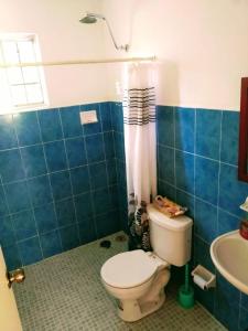 a bathroom with a toilet and a sink at La Casita Puerto Arista in Puerto Arista +30 photos