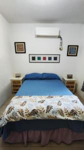 a bedroom with a bed and two night stands at La Casita Puerto Arista in Puerto Arista