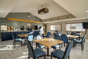 a restaurant with tables and chairs and a kitchen at Super 8 by Wyndham Hot Springs in Hot Springs