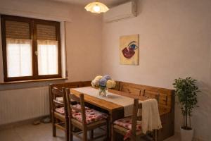 a dining room with a wooden table and chairs at Noi - Casa vacanza in Attimis