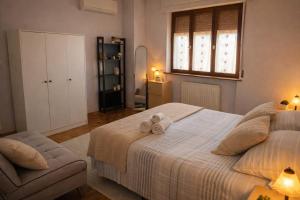 a bedroom with a bed with two towels on it at Noi - Casa vacanza in Attimis +9 photos