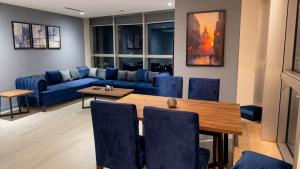 a living room with a blue couch and a table at Walk-Inn Centaurus Hotel Apartments Islamabad in Islamabad +112 photos