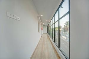 a hallway of a building with large windows at Open Hotel by Olive - Sadha Siva Airport Road, Chennai in Chennai