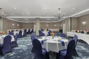 a banquet room with white tables and blue chairs at DoubleTree by Hilton Salisbury in Salisbury +15 photos