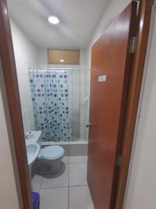 a bathroom with a toilet and a glass shower at Hallpa Ica in Ica