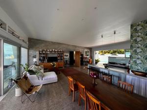 a large living room with a table and chairs at Ocean Escape Resort & Spa in Rarotonga