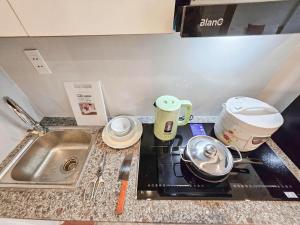 a kitchen counter with a sink and a stove top oven at Lakenest 06 - Quiet Place in Hanoi +86 photos