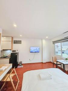 a room with a kitchen and a living room with a table at Lakenest 06 - Quiet Place in Hanoi