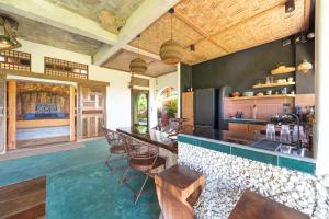 a bar with chairs and a counter in a room at Highlife Hill Villa in General Luna +30 photos