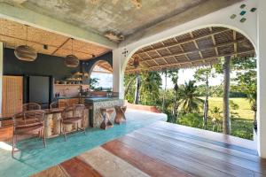 an open kitchen and living room with a view of the ocean at Highlife Hill Villa in General Luna