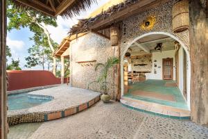 an entry way to a house with a swimming pool at Highlife Hill Villa in General Luna