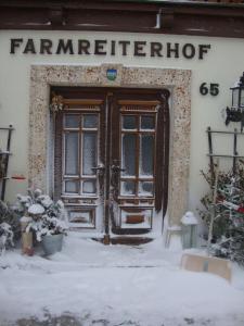 a front door of a building in the snow at Farmreiterhof in Pruggern