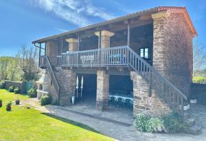 a brick house with a balcony and a staircase at Casa Bama in Bama