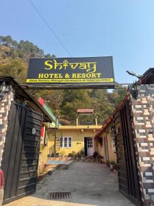 a sign for a hotel and resort on a building at Shivay Hotel & Resort in Dhārchula