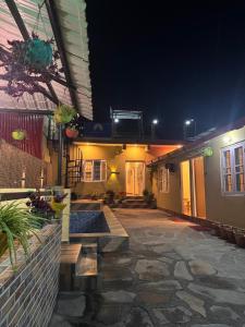 a courtyard of a building at night with lights at Shivay Hotel & Resort in Dhārchula
