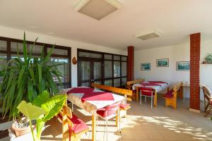 a room with two tables and chairs and some plants at Tinka, Zimmer No 5 in Starigrad