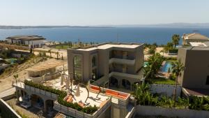 an aerial view of a building with the ocean in the background at No908 Sunset HOTEL in Çeşme