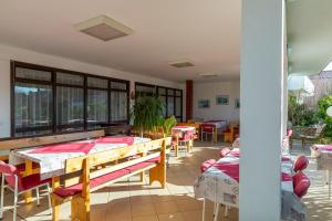 a room with tables and chairs and a patio at Tinka, Zimmer No 10 in Starigrad +4 photos