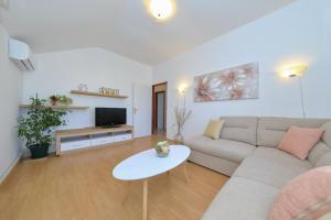 ein Wohnzimmer mit Sofa und Fernseher in der Unterkunft Antona in Šibenik