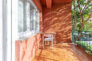 a chair sitting on a balcony next to a window at Tinka, Zimmer No 2 in Starigrad