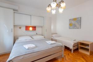 a bedroom with a large bed and a table at Tinka, Zimmer No 3 in Starigrad