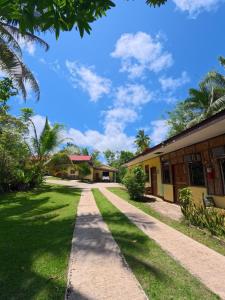 a walkway in front of a building at Xylla Guesthouse in Ytaya