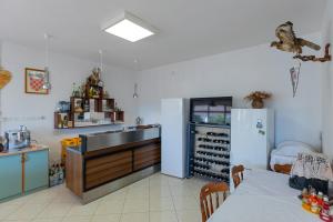 a kitchen with a sink and a refrigerator and a table at Tinka, Zimmer No 6 in Starigrad