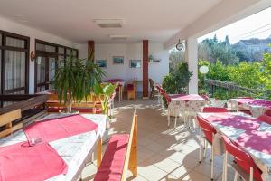 a restaurant with tables and chairs on a balcony at Tinka, Zimmer No 6 in Starigrad +4 photos