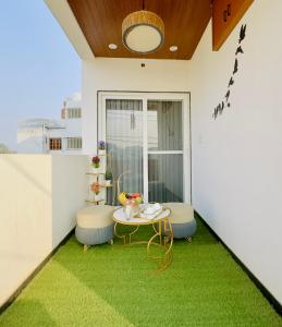 a balcony with a table and two stools at Sagar Villa Udaipur in Udaipur